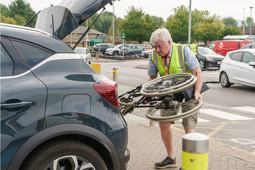 Community Connexion Helping Disabled Person Load Wheelchair in the Trunk