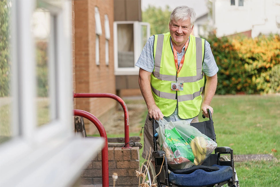 Volunteer Alan, carrying passengers shopping home