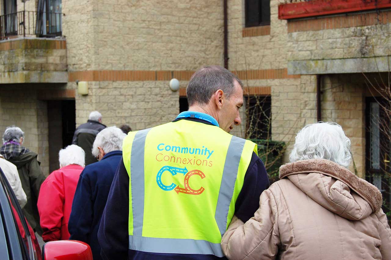 Community Connexions driver assisting passengers to a visitor centre